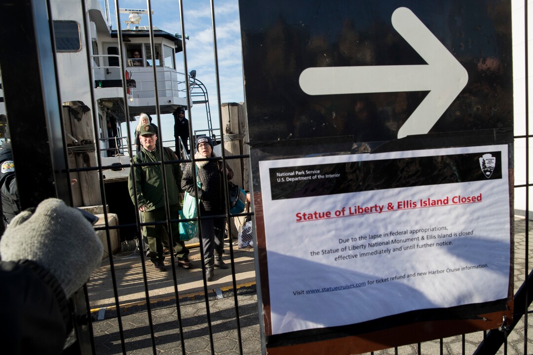 People who work at the Statue of Liberty and Ellis Island disembark from a ferry at Battery Park, Saturday, Jan. 20, 2018, in New York. The National Park Service announced that the Statue of Liberty and Ellis Island would be closed Saturday "due to a lapse in appropriations." Late Friday, the Senate failed to approve legislation to keep the government from shutting down after the midnight deadline. (AP Photo/Mary Altaffer)