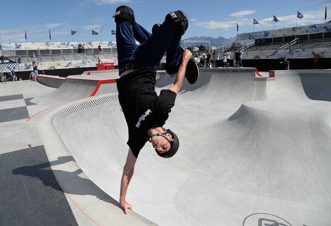 (Francisco Kjolseth  |  The Salt Lake Tribune)  Skate legend Tony Hawk delights the crowd with an invert as he joins other pro skaters for a community skate during a first look of the new Vans - Utah Sports Commission Skatepark at the Utah State Fairpark on Tuesday, Sept. 3, 2019.