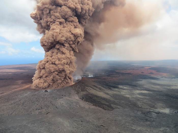 This Friday, May 4, 2018, aerial image released by the U.S. Geological Survey, at 12:46 p.m. HST, a column of robust, reddish-brown ash plume occurred after a magnitude 6.9 South Flank of Kīlauea earthquake shook the Big Island of Hawaii, Hawaii. The Kilauea volcano sent more lava into Hawaii communities Friday, a day after forcing more than 1,500 people to flee from their mountainside homes, and authorities detected high levels of sulfur gas that could threaten the elderly and people with breathing problems. (U.S. Geological Survey via AP)
