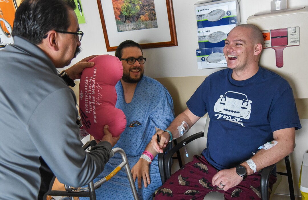 (Francisco Kjolseth  |  The Salt Lake Tribune)  Willie Salas,left,  gives Matthew Thompson a stuffed kidney to sign following his gift of life to his son Mitchell, center, as the two recover at Intermountain Medical Center in Murray following their kidney transplant surgery.  Once complete strangers to one another, Thompson agreed to meet the man he donated his kidney to as part of the Good Samaritan organ donor program. 