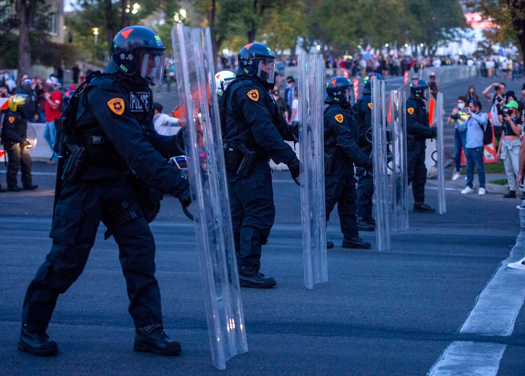(Rick Egan  |  The Salt Lake Tribune) Protesters face a  line of police in riot gear on 1300 East and 200 South, near the University of Utah where Mike Pence is debating Kamala Harris on Wednesday, Oct. 7, 2020.