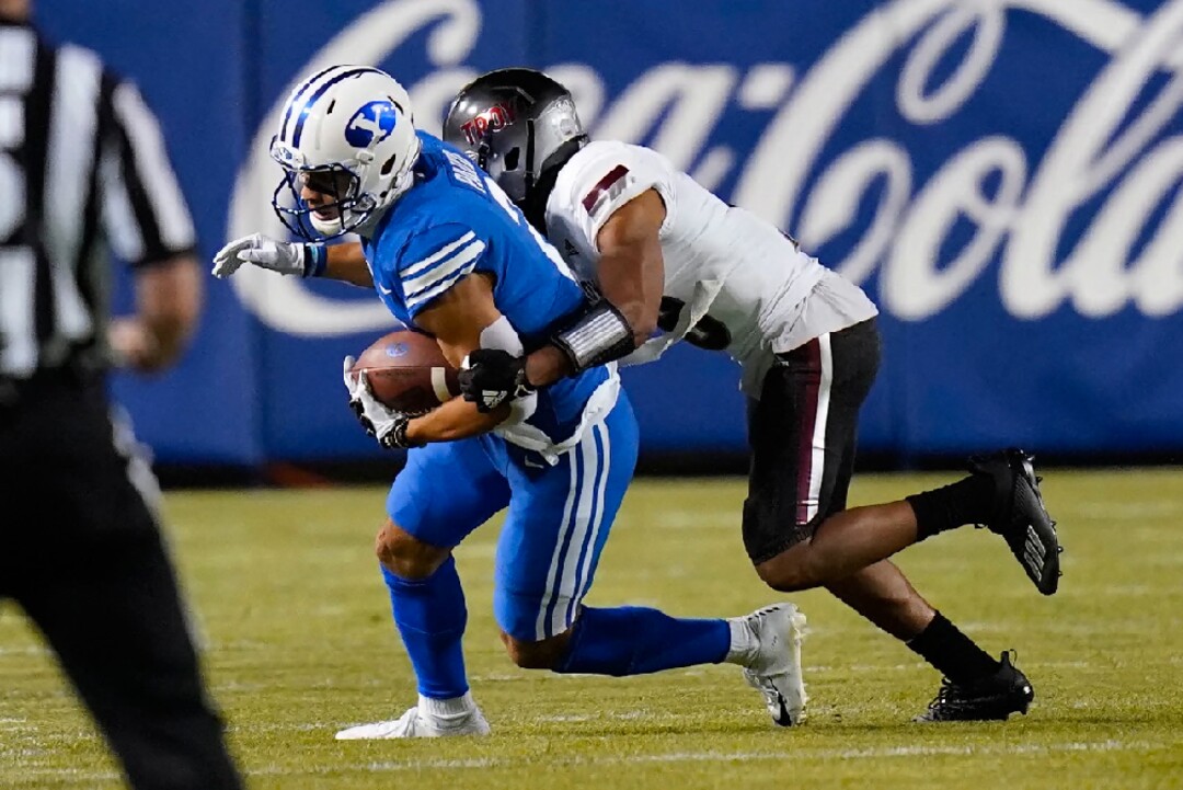 Troy cornerback Reddy Steward, right, tackles BYU wide receiver Neil Pau'u during the first half of an NCAA college football game Saturday, Sept. 26, 2020, in Provo, Utah. (AP Photo/Rick Bowmer, Pool)