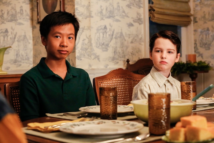 (Photo: Robert Voets/CBS) Tam (Ryan Phuong) eats dinner with Sheldon (Iain Armitage) and his family on “Young Sheldon.”