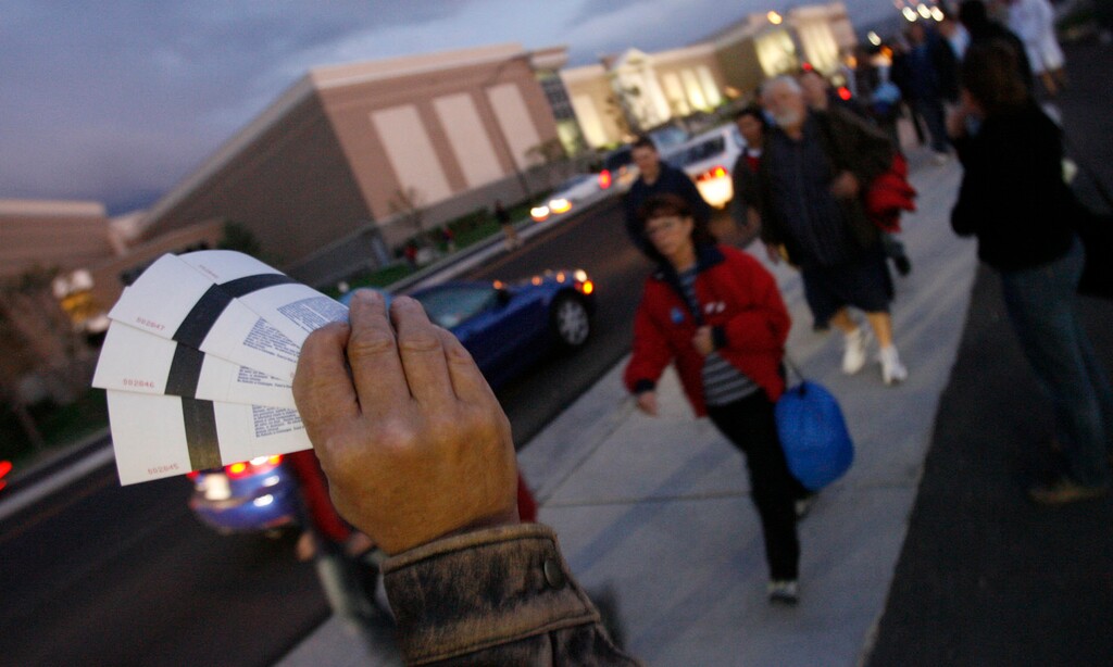 (Leah Hogsten  |  Tribune file photo)  A scalper sells tickets along State Street in Sandy before Real Salt Lake's first game at Rio Tinto Stadium in 2008.
