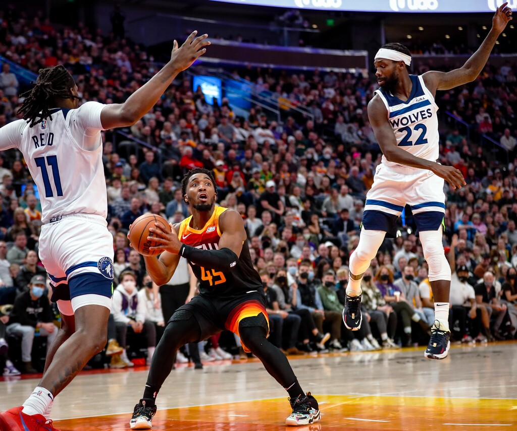 (Adam Fondren | The Associated Press) Utah Jazz guard Donovan Mitchell (45) looks for a shot as Minnesota Timberwolves center Naz Reid (11) and guard Patrick Beverley (22) defend during the second half of an NBA basketball game Friday, Dec. 31, 2021, in Salt Lake City.