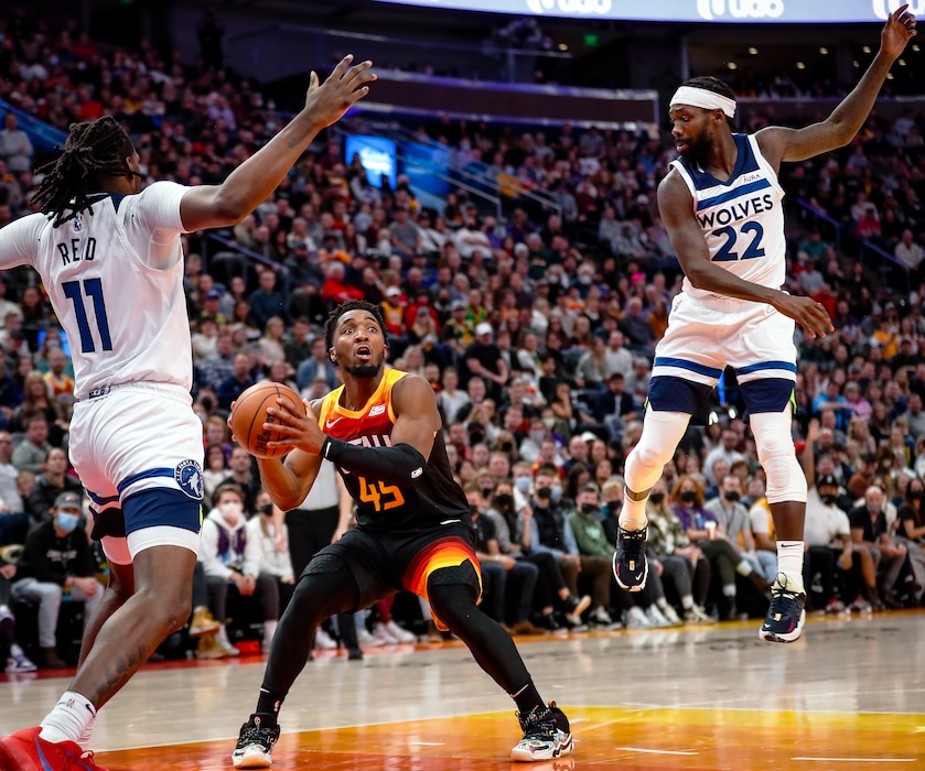 (Adam Fondren | The Associated Press) Utah Jazz guard Donovan Mitchell (45) looks for a shot as Minnesota Timberwolves center Naz Reid (11) and guard Patrick Beverley (22) defend during the second half of an NBA basketball game Friday, Dec. 31, 2021, in Salt Lake City.