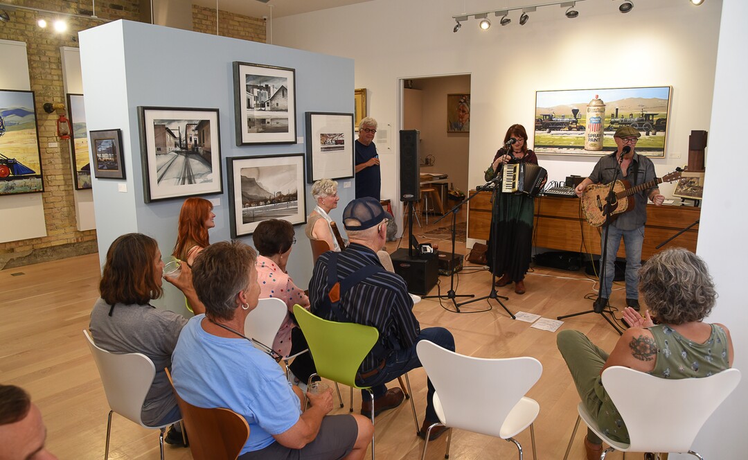 (Francisco Kjolseth  |  The Salt Lake Tribune)  Visitors take in live music for Helper First Fridays in the gallery created by Roy and Anne Jespersen, who converted a former grocery store over twenty years ago. Invested in the small town of Helper, discovered by a variety of artists and dreamers seeking to escape the hustle of the Wasatch Front, Roy Jespersen, an expert in nonprofits and his wife Anne, a noted architect moved to town, bought the old Main Street building, and turned it into a high end art studio and gallery in the front and a stunning home in the back.
