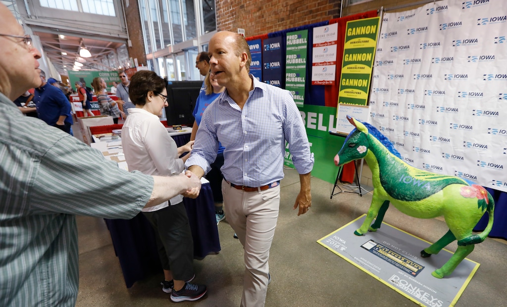 Rep. John Delaney, D-Md., greets a fairgoer during a stop at the Iowa Democratic Party booth during a visit to the Iowa State Fair, Friday, Aug. 10, 2018, in Des Moines, Iowa. (AP Photo/Charlie Neibergall)