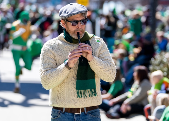 (Rick Egan | The Salt Lake Tribune) Kevin Flynn plays the penny whistle, in the St. Patrick's Parade, in Salt Lake City, on Saturday, March 12, 2022.