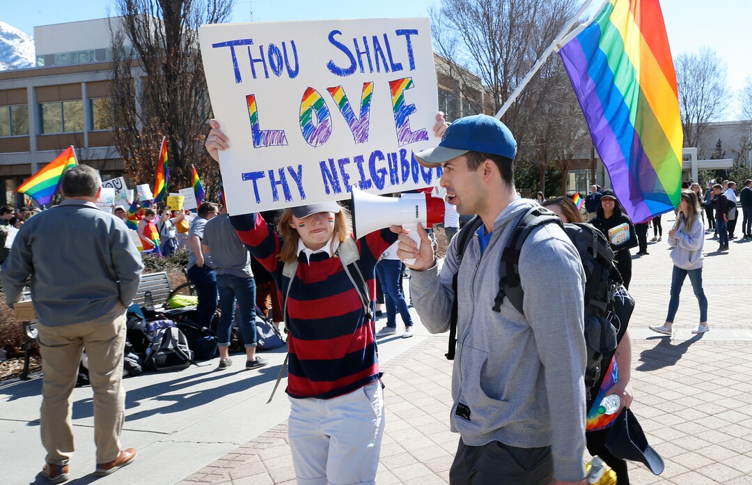 (George Frey  |  special to The Salt Lake Tribune) A BYU student only identified as Chris, is confronted by protesters as he shouts in his bull horn ÒtransferÓ in front of the Ernest L. Wilkinson Student Center on the campus of Brigham Young University in protest of BYUÕs rollback of a newly announced policy change on LGBTQ students in the campus of Brigham Young University on March 5, 2020 in Provo, Utah.