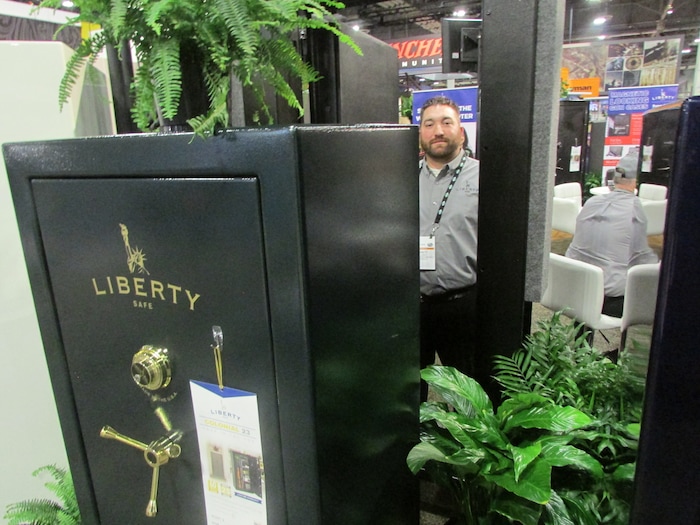 (Tom Wharton | Special to The Tribune) Brett Lafferty of Payson's Liberty Safe, stands at the SHOT Show in Las Vegas on Jan. 23, 2018, in front of a vault door the company is manufacturing for homes that may have a concrete storage room under their porches.