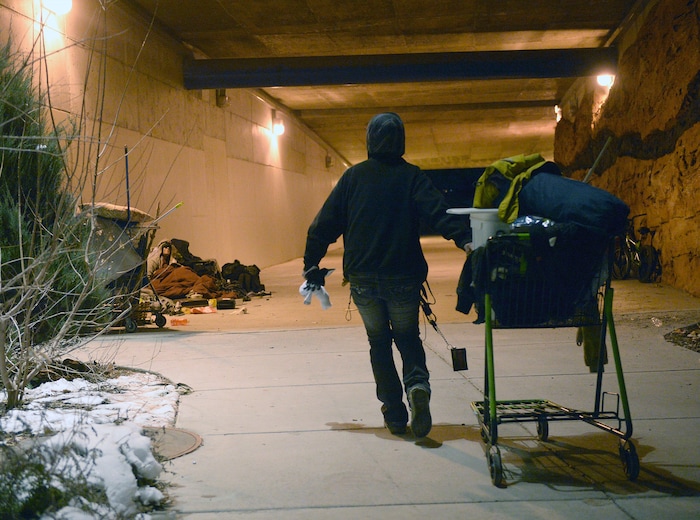 (Al Hartmann | The Salt Lake Tribune) Tammy, who said that she's been homeless for the past 13 years, pulls her cart with belongings into the tunnel at Sugar House Park where a few friends are camping on Thursday, Jan. 25, 2018.