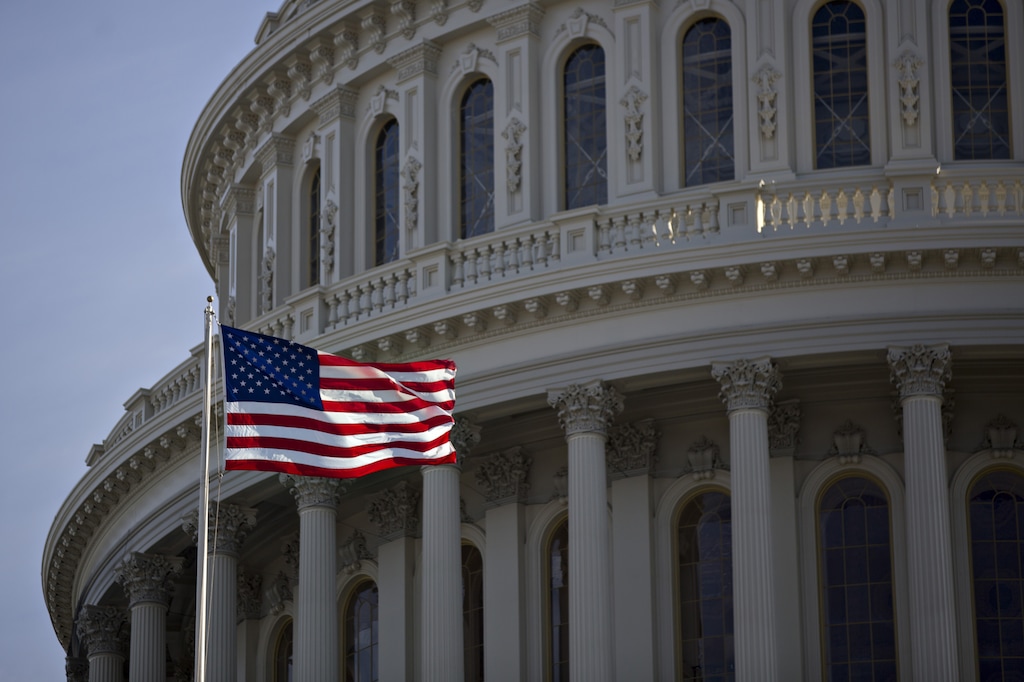 The American flag flies next to the dome of the U.S. Capitol building on Jan. 15, 2017. (Andrew Harrer | Bloomberg)
