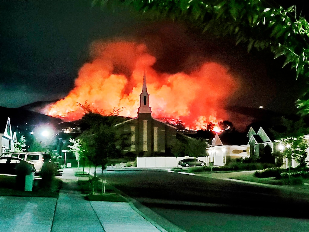 (Justin Reeves via AP)
The Traverse Fire burns behind homes in Lehi, Utah, Sunday, June 28, 2020. Officials say fireworks caused the wildfire and forced evacuations early Sunday morning.