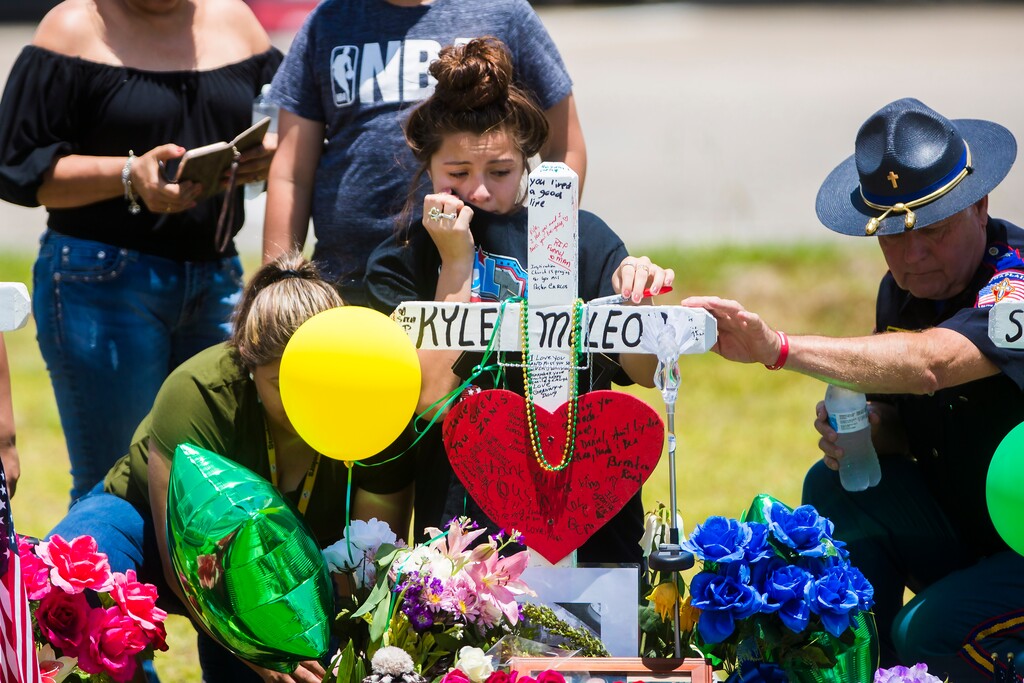 (Marie D. De Jesus/Houston Chronicle via AP) A young woman cries, Tuesday, May 22, 2018, by a memorial for Santa Fe High School freshman Aaron Kyle McLeod, who was killed Friday during a shooting at the school in Santa Fe, Texas.