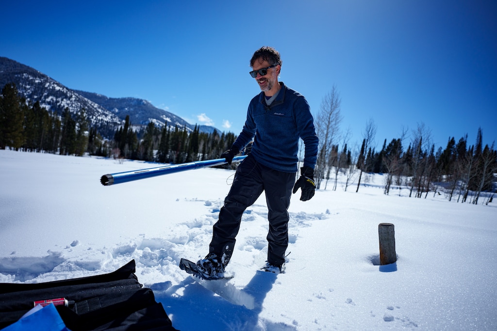(Trent Nelson  |  The Salt Lake Tribune) Jordan Clayton with a snow sampler at the Tony Grove SNOTEL site on Friday, March 8, 2024.