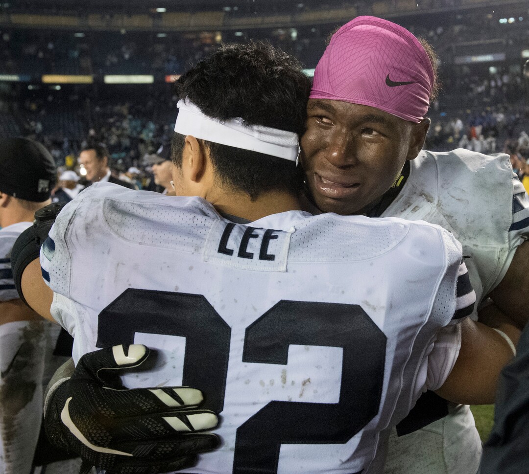 Rick Egan  |  The Salt Lake TribuneBrigham Young Cougars running back Jamaal Williams (21) hugsBrigham Young Cougars defensive back Hiva Lee (22) as BYU defeated Wyoming 24-21, in football action in thePoinsettia Bowl, at Qualcomm Stadium in San Diego, December 21, 2016.