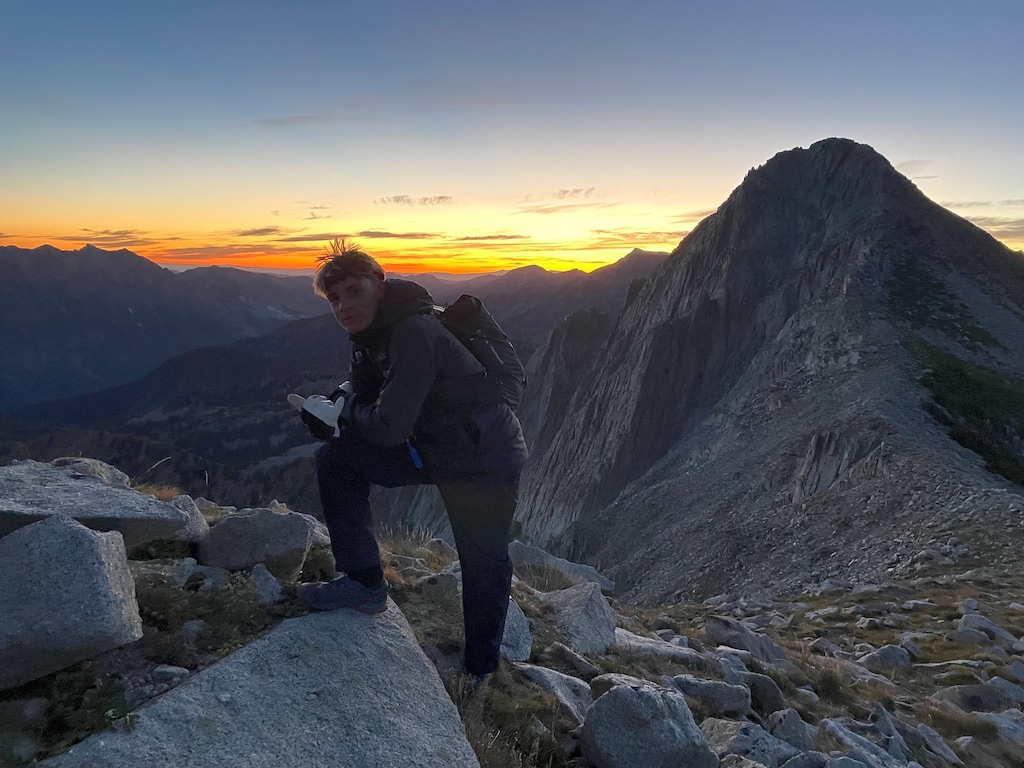 (Eddie Gerritsen) Jesse Zurinskas, 15, soaks in the sunrise from the Unnamed Peak West of Pfeifferhorn (UPWOP) on Aug. 10, 2025, during his attempt to become the youngest to complete the Wasatch Ultimate Ridge Linkup (WURL). Zurinskas finished the 36-mile route around the Little Cottonwood Canyon ridgeline in 35 hours, 32 minutes.