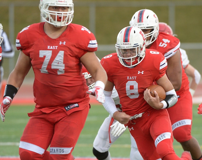 (Leah Hogsten  |  The Salt Lake Tribune) East's quarterback Ben Ford gets a path cleared by Stone Angilau. American Fork High School boys' football team East High School during their class 6A state quarterfinal football game, Friday, November 3, 2017