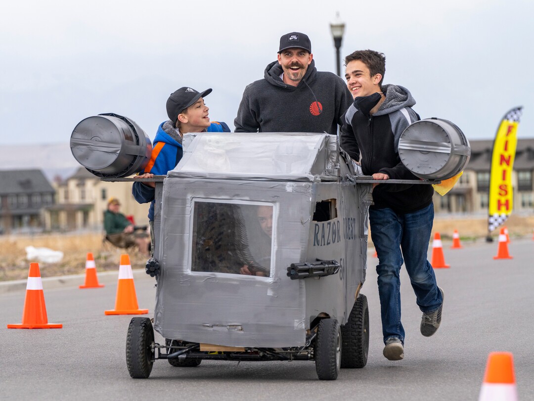 (Rick Egan | The Salt Lake Tribune) Cael McBride, Joe Lee, and Haven McBride push the "Razor Crest" back to the finish line for another race as driver Maevie McBride rides along, after winning the last heat, in the Freestyle Division, at the Daybreak Soap Box Derby, on Saturday, April 24, 2021.