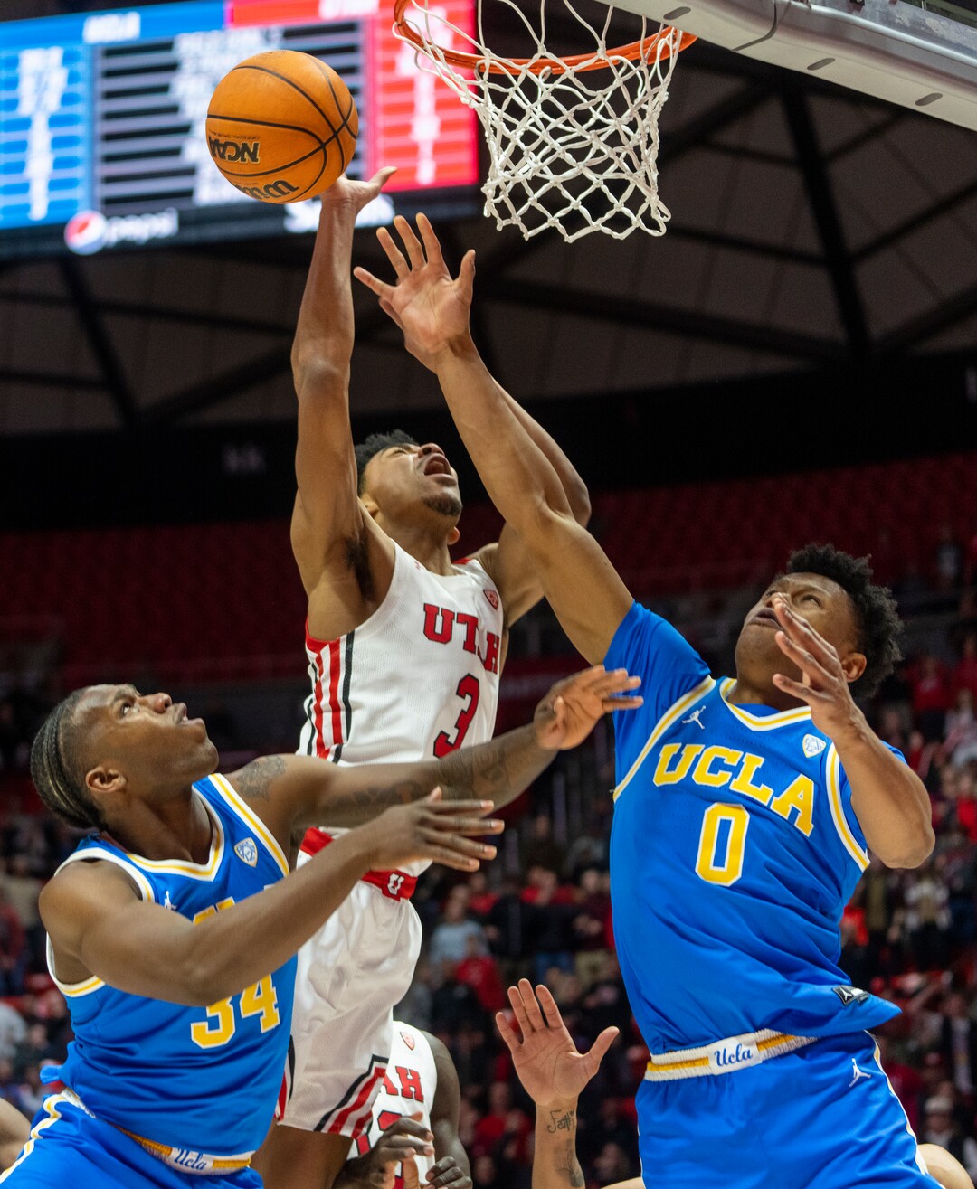 (Rick Egan | The Salt Lake Tribune) UCLA Bruins guard Jaylen Clark (0) blocks a shot by Utah Utes forward Bostyn Holt (3), in PAC-12 basketball action between Utah Utes and UCLA Bruins, at the Jon M. Huntsman Center, Thursday, February. 23, 2022.