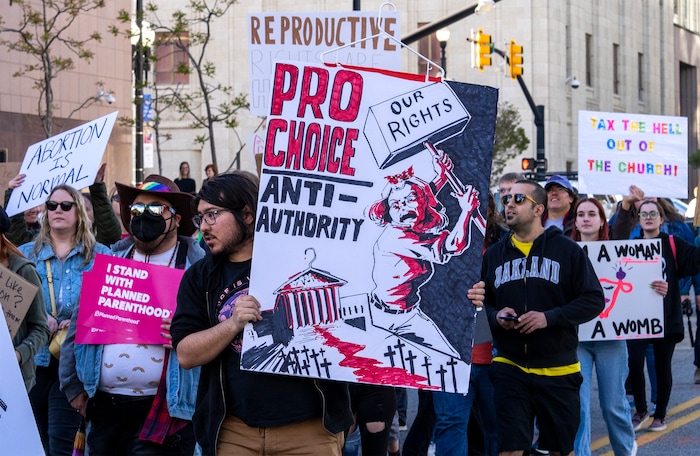 (Rick Egan | The Salt Lake Tribune) Hundreds of protesters march down State Street after a bans off our bodies protest hosted by Planned Parenthood, on Tuesday, May 3, 2022.
