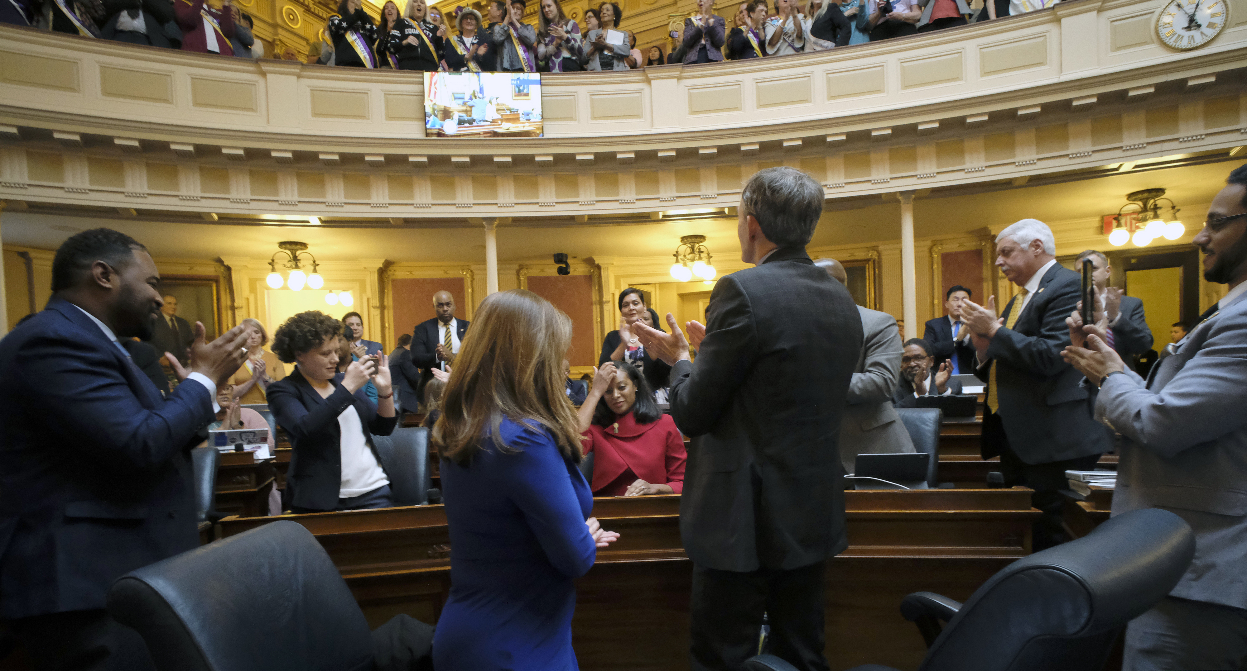 (Bob Brown | Richmond Times-Dispatch via AP) Del. Jennifer Carroll Foy, D-Prince William, seated center, is applauded by fellow members and Equal Rights Amendment supporters in the House of Delegates gallery after she spoke for passage of the ERA resolution she sponsored, Wednesday, Jan. 15, 2020, at the state Capitol in Richmond, Va.