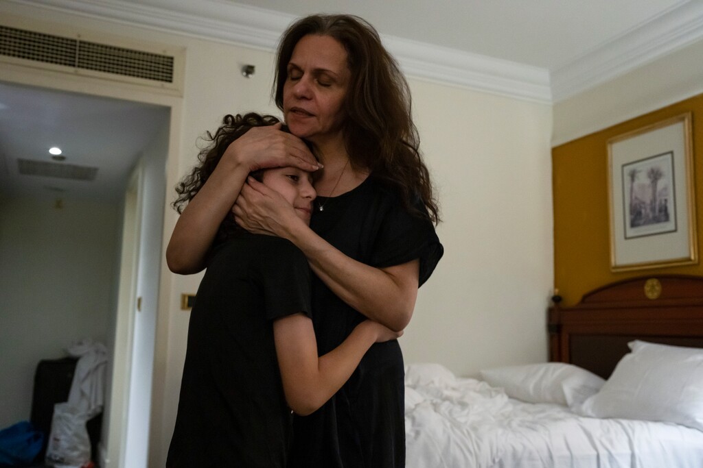 (Nariman El-Mofty | The New York Times) Lena Beseiso, a Palestinian who holds a U.S. passport, checking the temperature of her 10-year-old grandson, Aden, in a hotel room in Cairo on Nov. 3, 2023. Beseiso and two of her daughters became trapped in Gaza when Israeli bombardments began in response to the Hamas attack on Oct. 7.