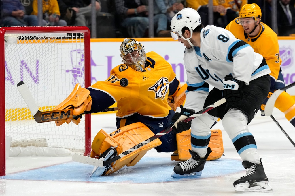 Nashville Predators goaltender Juuse Saros (74) blocks a shot by Utah Hockey Club center Nick Schmaltz (8) during the first period of an NHL hockey game Saturday, Nov. 9, 2024, in Nashville, Tenn. (AP Photo/Mark Humphrey)
