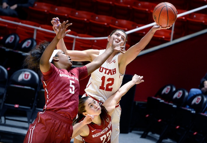 Scott Sommerdorf   |  The Salt Lake Tribune  
Utah Utes forward Emily Potter (12) reaches for a rebound while sandwiched between Washington State Cougars forward Kayla Washington (5) and Washington State Cougars guard Pinelopi Pavlopoulou (22) during first half play. Washington State led Utah 27-22 at the half, Sunday, February 5, 2017. 