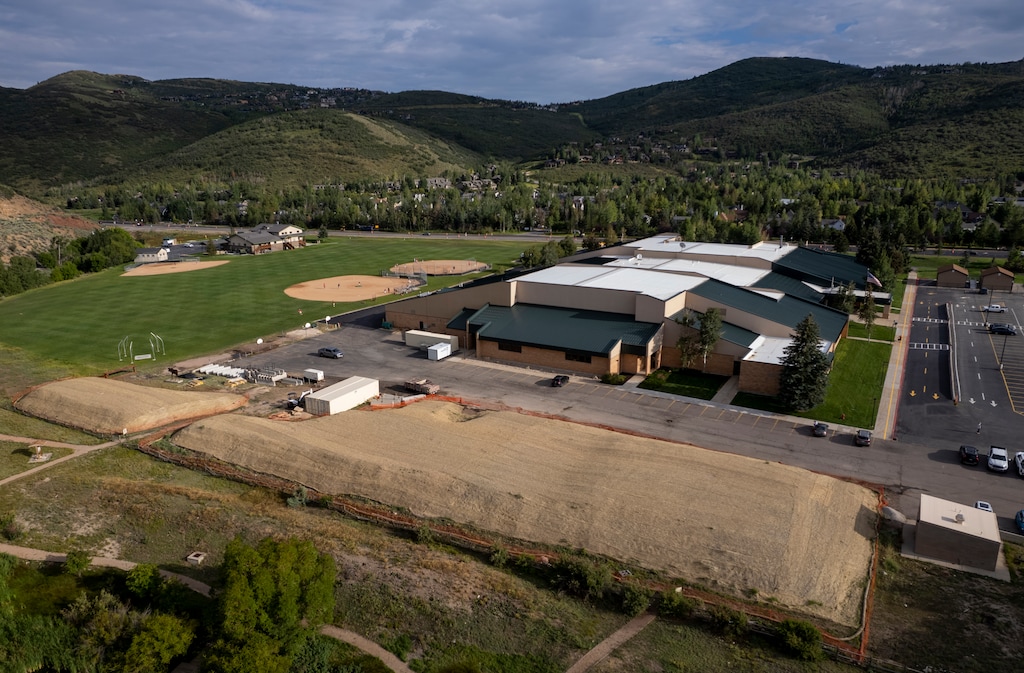 (Rick Egan | The Salt Lake Tribune) Contaminated soil piles sit behind Treasure Mountain Junior High in Park City on August 24, 2023. 