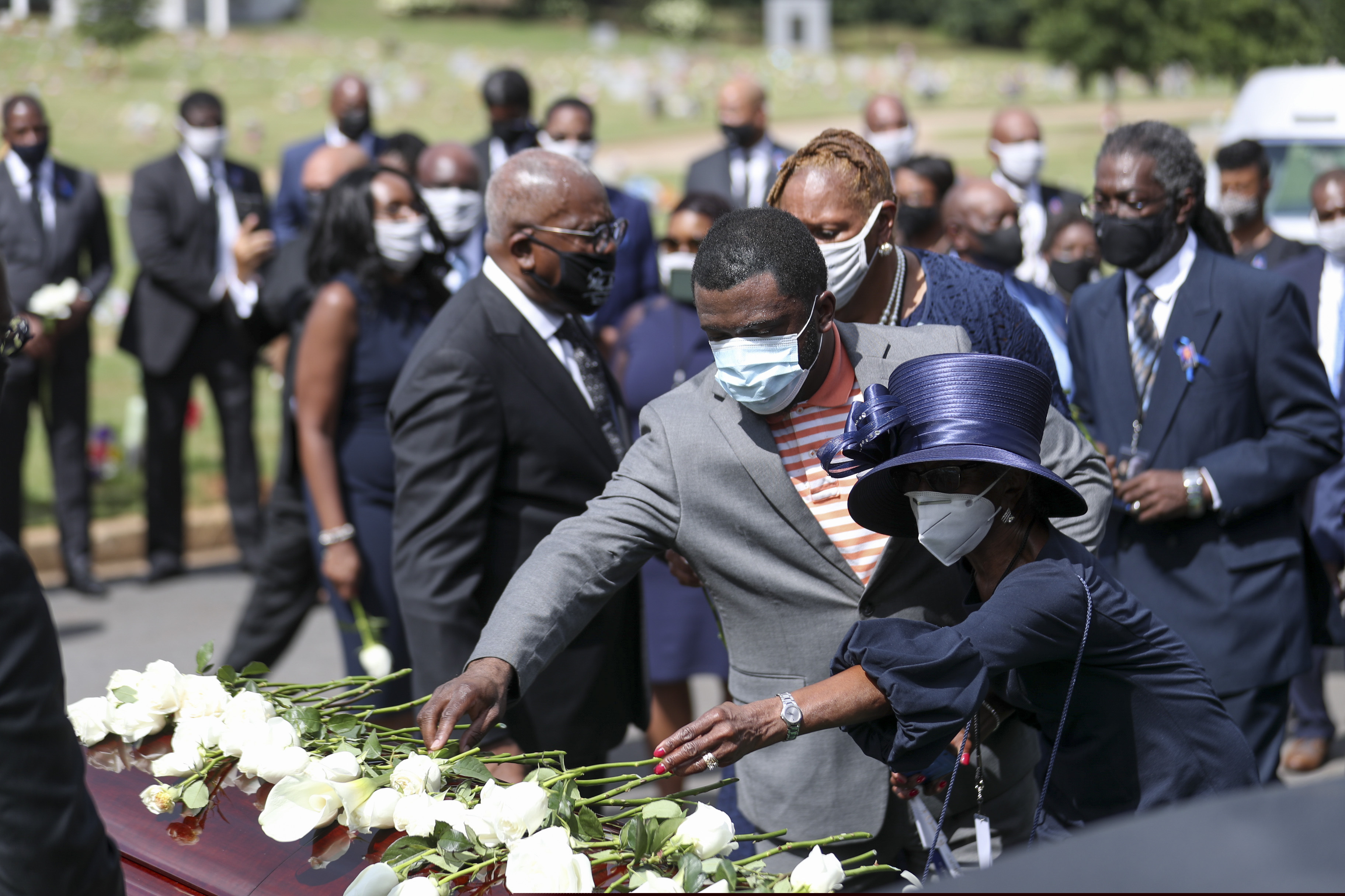 Family members place flowers on the casket of Rep. John Lewis during the burial service at South-View Cemetery in Atlanta Thursday, July 30, 2020. (Alyssa Pointer/Atlanta Journal-Constitution via AP, Pool)