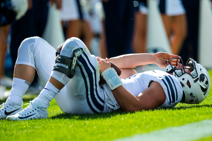 (Chris Detrick  |  The Salt Lake Tribune)  Brigham Young Cougars quarterback Beau Hoge (7) remains on the ground after being tackled for a safety by Wisconsin Badgers linebacker Tyler Johnson (59) during the game at LaVell Edwards Stadium Saturday Saturday, September 16, 2017. Wisconsin Badgers defeated Brigham Young Cougars 40-6.