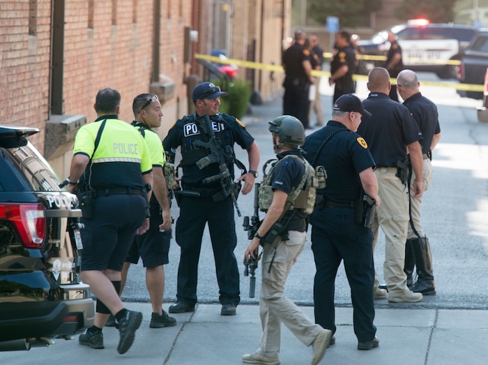 (Rick Egan  |  The Salt Lake Tribune)   Police stand by on 400 south across from Pioneer Park, after a suspect that fired shots at a police officer was found dead in a nearby building, of an apparent self-inflicted gunshot.  Wednesday, Sept. 5, 2018.


