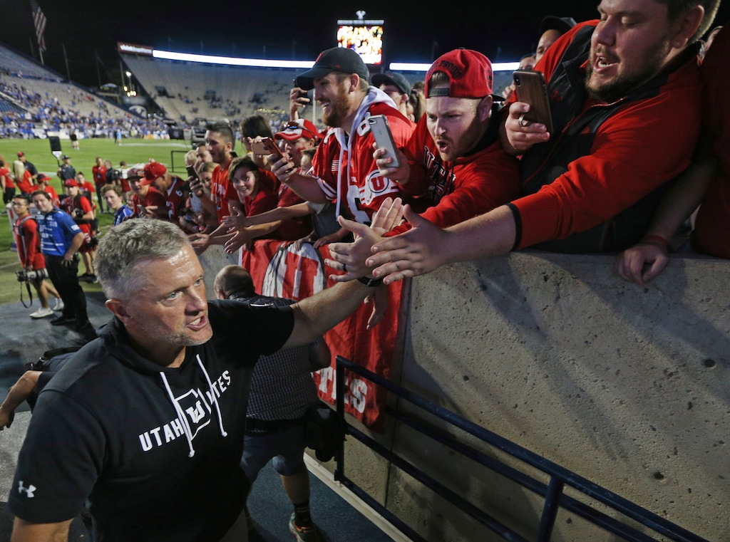 Utah head coach Kyle Whittingham greets fans after defeating BYU at an NCAA college football game, Thursday, Aug. 29, 2019, in Provo, Utah. Utah defeated BYU 30-12. (AP Photo/George Frey)