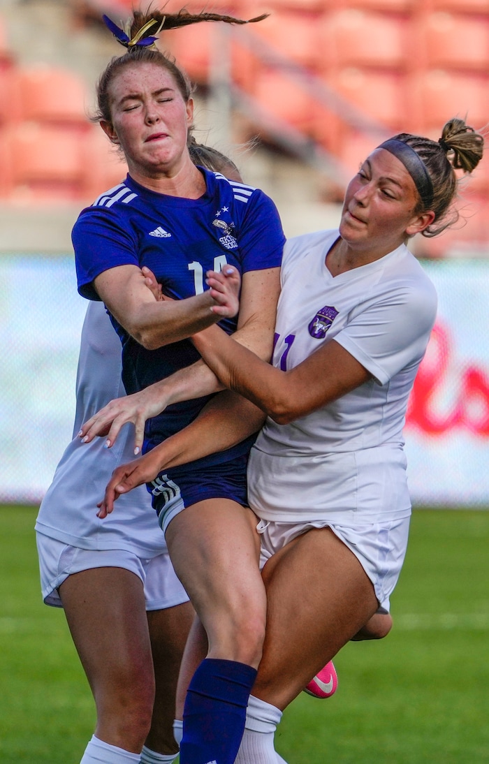 (Leah Hogsten | The Salt Lake Tribune) Lehi's Kamara Simmons (7) and Calista Wren (11) sandwich Skyline's Ella Carmody (14) during the 5A State Soccer Championship game on Friday. Skyline High School defeated Lehi High School, 3-1 to win the 5A Championship title Oct. 22, 2021 at Rio Tinto Stadium.
