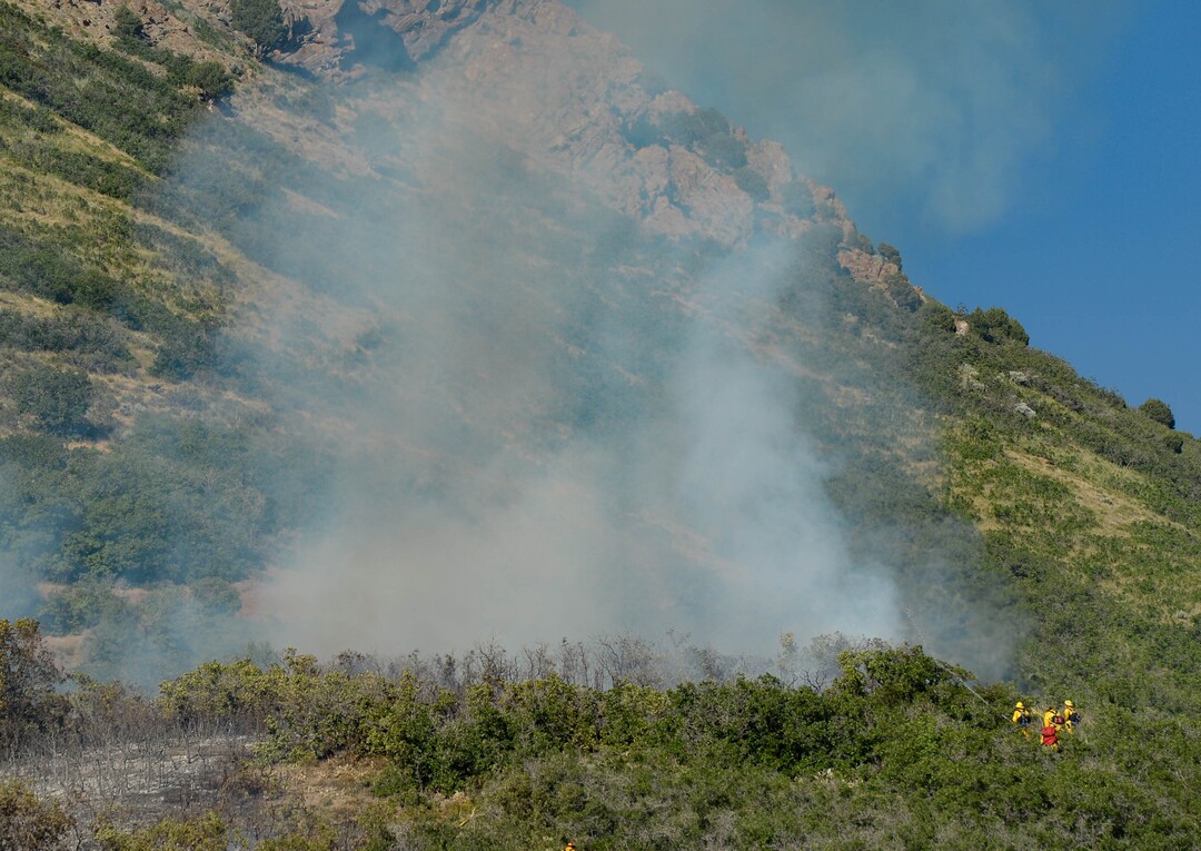 (Francisco Kjolseth  |  The Salt Lake Tribune) Fire crews battle a fire near Millcreek Canyon, on Saturday, July 11, 2020, started near 3400 South Crestwood Dr., as helicopters, single engine air tankers and multiple crews respond.