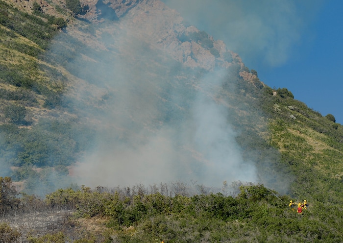 (Francisco Kjolseth  |  The Salt Lake Tribune) Fire crews battle a fire near Millcreek Canyon, on Saturday, July 11, 2020, started near 3400 South Crestwood Dr., as helicopters, single engine air tankers and multiple crews respond.
