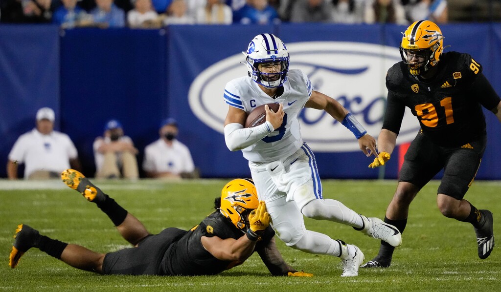 (Francisco Kjolseth | The Salt Lake Tribune) Brigham Young Cougars quarterback Jaren Hall (3) outmaneuvers the Arizona State Sun Devils defense in the 4th quarter of play at LaVell Edwards Stadium in Provo, on Saturday, Sept. 18, 2021.
