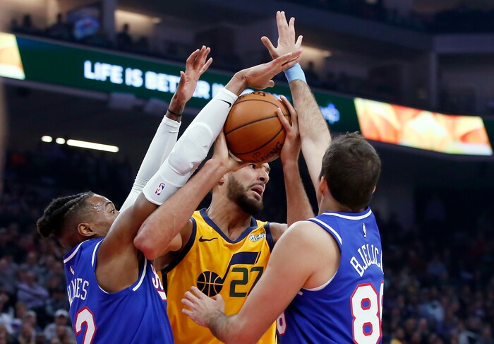 Utah Jazz center Rudy Gobert, center, works for a rebound between Sacramento Kings' Richaun Holmes, left and Nemanja Bjelica during the first quarter of an NBA basketball game in Sacramento, Calif., Friday, Nov. 1, 2019. (AP Photo/Rich Pedroncelli)