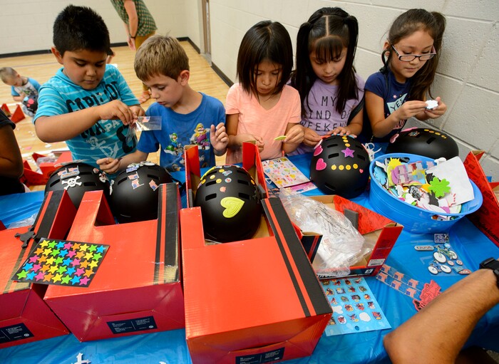 Steve Griffin  |  The Salt Lake TribuneKids at the Lied Boys & Girls Club decorate their new bike helmets donated by UnitedHealthcare to help encourage kids and families to participate in the Tour of Utah kidsÕ events. Club youth will received the helmets and a helmet-fitting from UnitedHealthcare Pro Cycling Team members, as well as a lesson in helmet and bike safety in Salt Lake City Friday July 28, 2017.