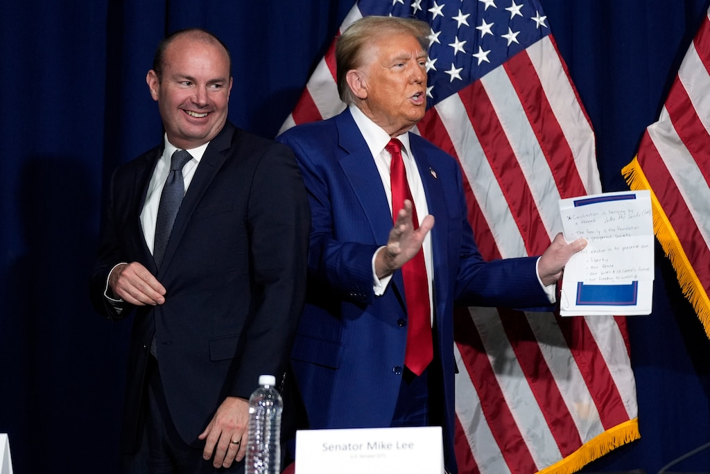 (Evan Vucci | AP) Donald Trump with Sen. Mike Lee, R-Utah, in fall 2024. Lee is calling for an investigation of a social media post by Trump critic James Comey.