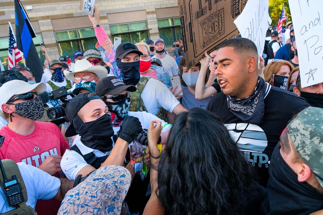 (Leah Hogsten  |  The Salt Lake Tribune) Landon Daniel Buttars, 21, and Emanuel "Mani" Hill, 21, are pulled apart Black Lives Matter protest in Cottonwood Heights in August. Five days after after nine protesters were arrested during a rally in memory of Zane James that turned into a violent clash with Cottonwood Heights officers, demonstrators gathered outside the police station Friday to denounce CHPD’s actions and its officers for inciting the violence.