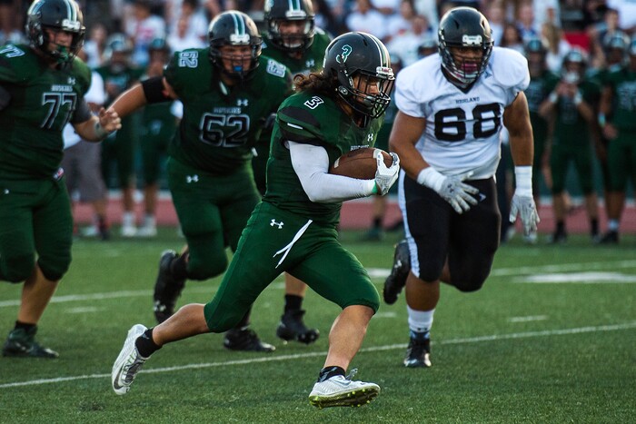 (Chris Detrick  |  The Salt Lake Tribune)    Hillcrest's Alex Cardona (3) runs the ball past Highland's KJ Pakofe (68) during the game at Hillcrest High School Friday, September 1, 2017. 