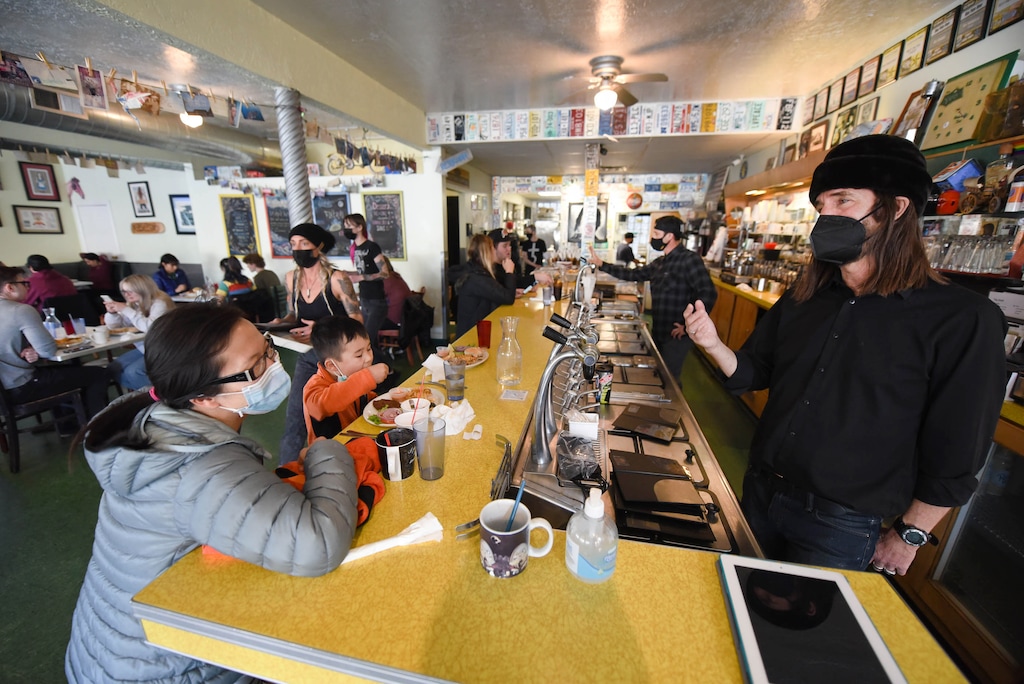 (Francisco Kjolseth  | The Salt Lake Tribune) Yoon Kim-Butterfield, left, a regular to Blue Plate Diner with her sons Nikko and Koji, finds out for the first time that the restaurant will be closing from owner John Bouzek during a breakfast stop on Friday, March 12, 2021. In business for 20 years, a new development is going in on the corner that is forcing it to shut down.