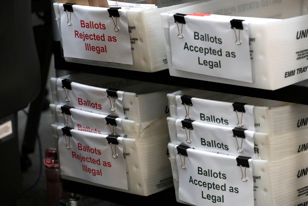 (Lynne Sladky | AP file photo)  Boxes for vote-by-mail ballots are shown at the Miami-Dade County Elections Department, Thursday, July 30, 2020, in Doral, Fla.