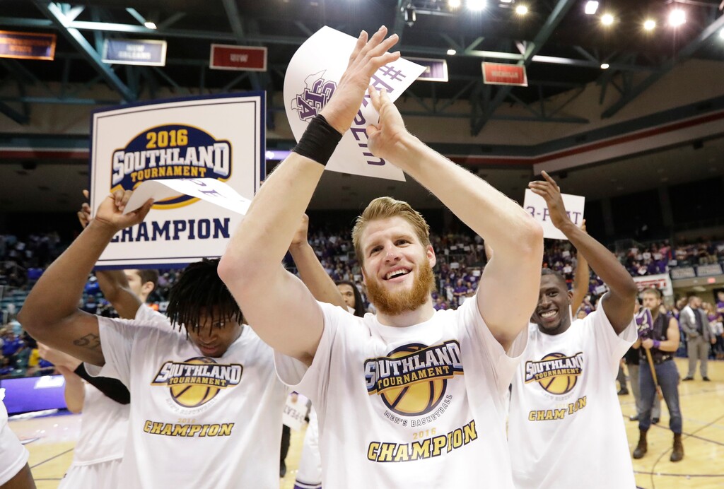 FILE - In this March 12, 2016, file photo, Stephen F. Austin's Thomas Walkup, center, celebrates with teammates after an NCAA college basketball game against Texas A&M-Corpus Christi for the Southland Conference men's tournament title in Katy, Texas. Stephen F. Austin won 82-60. Stephen F. Austin, which dominated the Southland season and received a double bye in the league tournament, made the NCAAs, beat West Virginia and nearly knocked off Notre Dame as well. (AP Photo/David J. Phillip, File)
