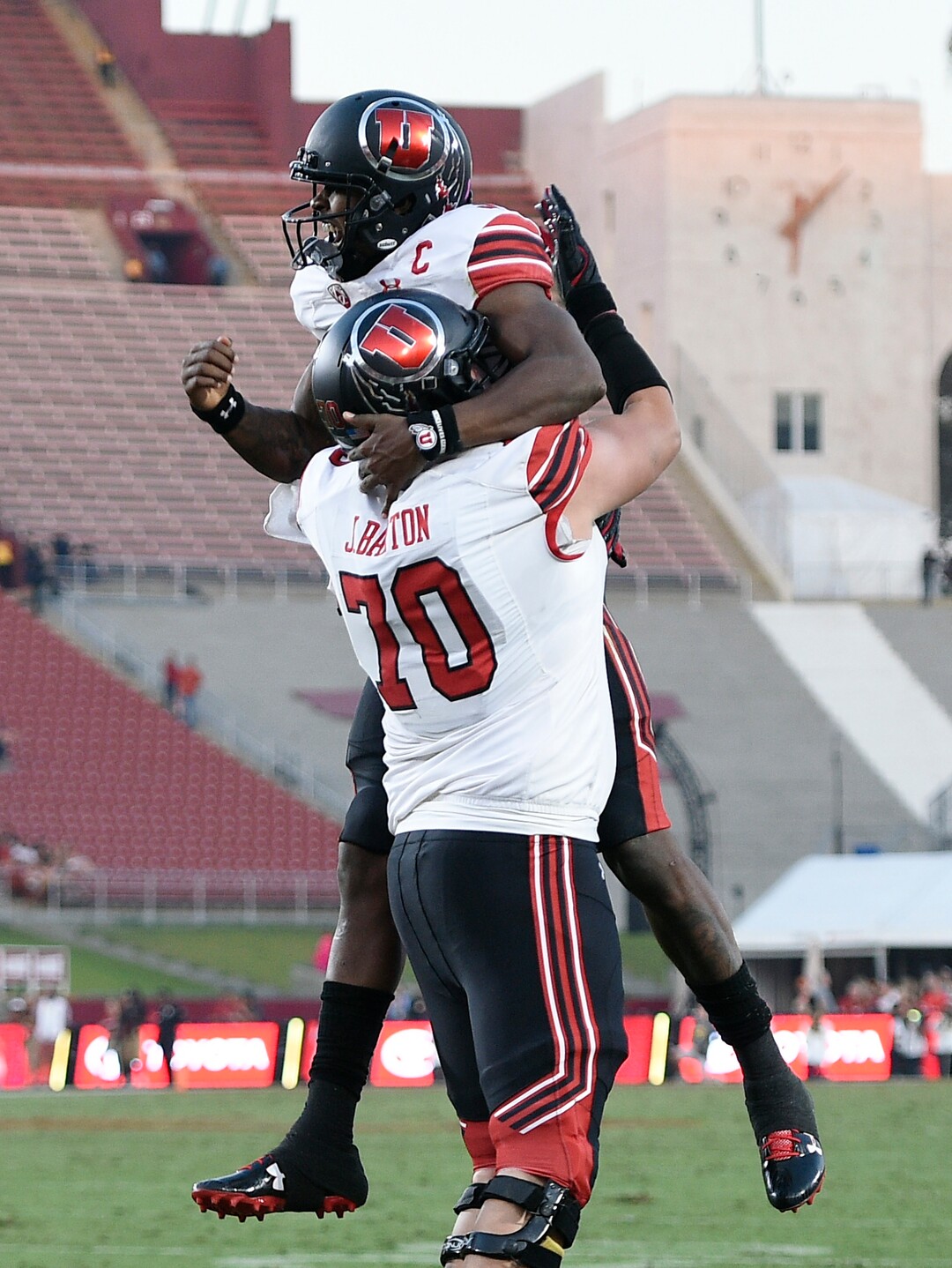 Utah quarterback Troy Williams, top, celebrates with offensive lineman Jackson Barton after a touchdown during the first half of an NCAA college football game against Southern California in Los Angeles, Saturday, Oct. 14, 2017. (AP Photo/Kelvin Kuo)