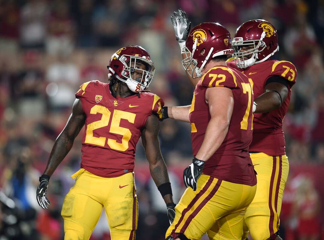 Southern California running back Ronald Jones II, left, celebrates with guard Andrew Vorhees, center, and offensive tackle Austin Jackson after scoring during the second half of an NCAA college football game against Utah in Los Angeles, Saturday, Oct. 14, 2017. USC won 28-27. (AP Photo/Kelvin Kuo)