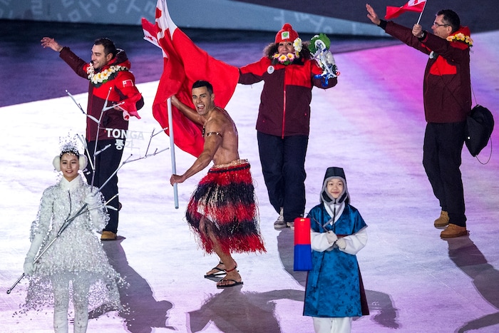(Chris Detrick  |  The Salt Lake Tribune)  Pita Taufatofua carries the flag of Tonga during the Pyeongchang 2018 Winter Olympics opening ceremony at Olympic Stadium Friday, February 9, 2018.  